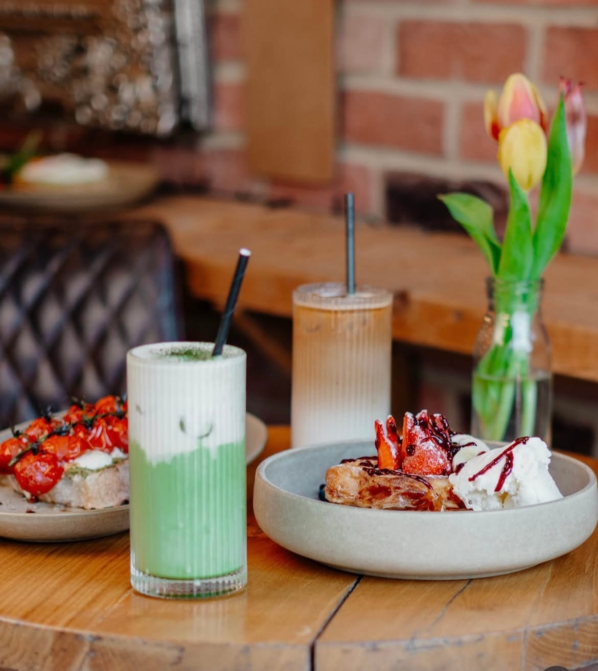 Iced matcha and coffee beside French toast and savoury toast at Steam & Bean