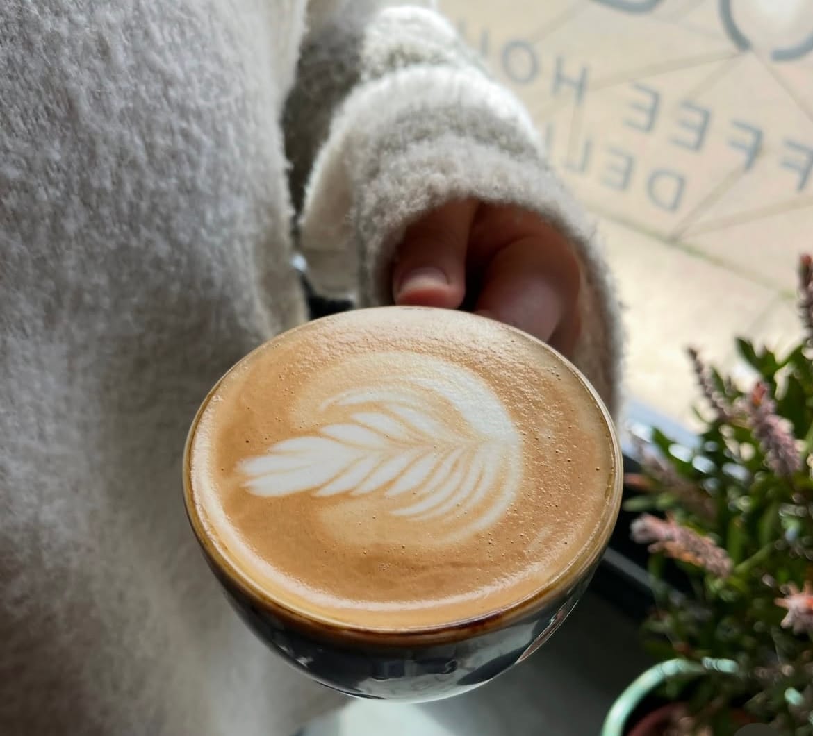 Latte art in a glass cup at Steam & Bean
