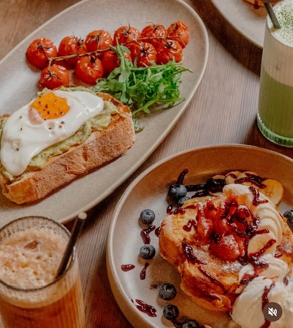 French toast with fruit and a plate of savoury toast at Steam & Bean